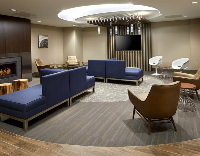Lobby of The Lodge at Duke Medical Center, lounge chairs, small tables and fireplace.