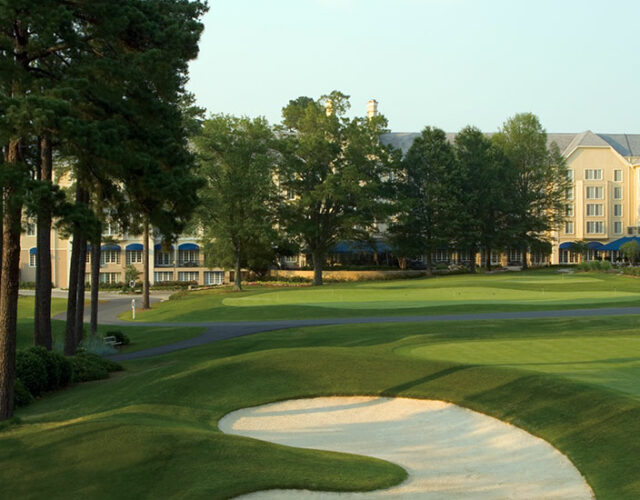 Dark green golf course with tall trees at Washington Duke Inn & Golf Club.